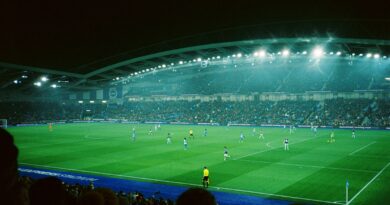 Floodlit football stadium during a night match, reflecting the post-World Cup 2026 surge in player market values