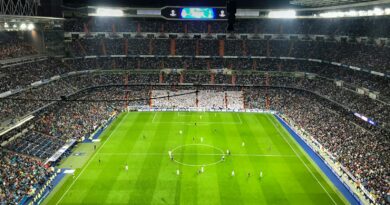 Football match under floodlights in a packed stadium, illustrating the summer 2026 transfer battle for Rodri