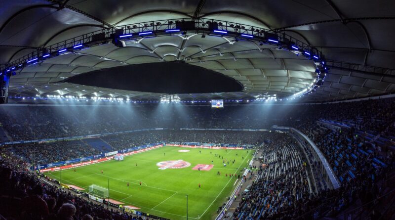 A floodlit football stadium glowing at night as the Premier League 2026/27 season kicks off