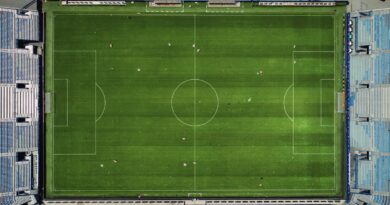 Aerial view of a floodlit football stadium and pitch, illustrating the summer 2026 Premier League transfer window