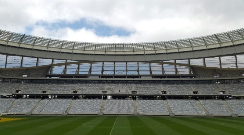 A large football stadium under a cloudy sky, illustrating Newcastle United's summer 2026 transfer teardown and squad rebuild