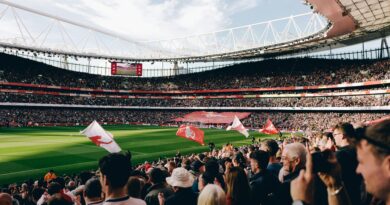 Fans fill the Emirates Stadium under floodlights for a Premier League match
