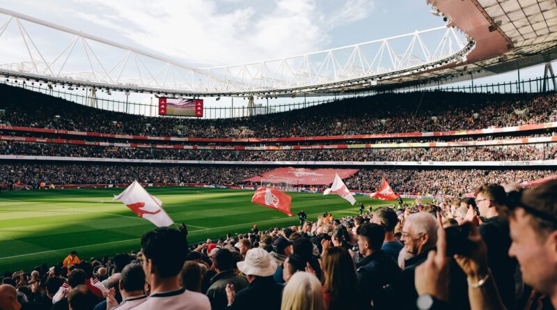 Fans fill the Emirates Stadium under floodlights for a Premier League match
