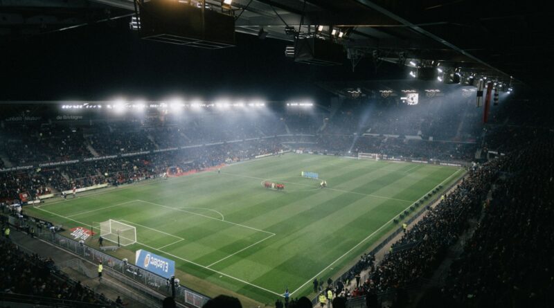Football stadium under floodlights at night ahead of the 2026 Premier League transfer deadline day