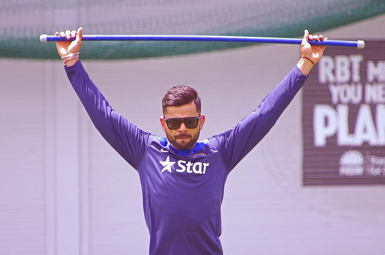 Virat Kohli stretches with a bat during an India training session in January 2015.